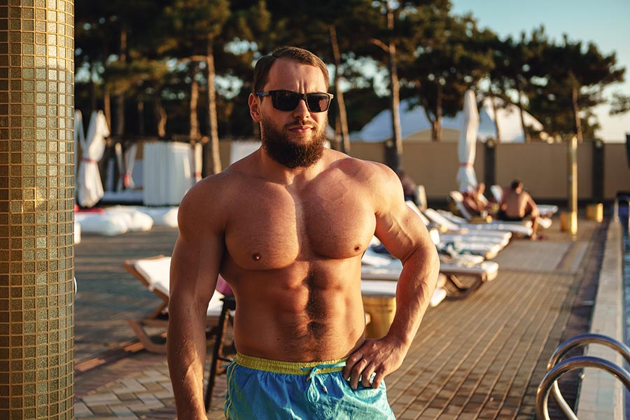 muscular-man-bodybuilder-tanning-in-a-beach-club
