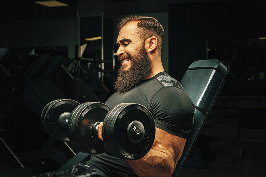 male-with-sport-body-lifting-dumbbells-at-the-gym